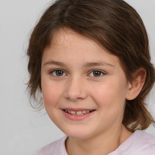 Joyful white child female with medium  brown hair and brown eyes