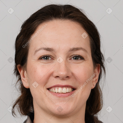 Joyful white adult female with medium  brown hair and brown eyes