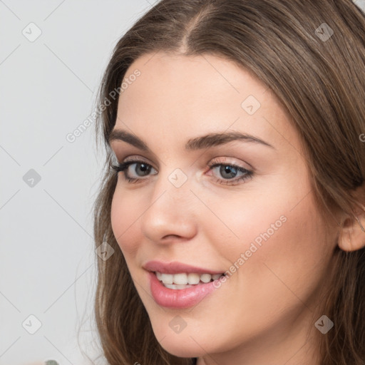 Joyful white young-adult female with long  brown hair and grey eyes