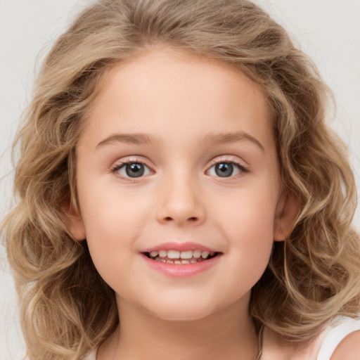 Joyful white child female with medium  brown hair and brown eyes