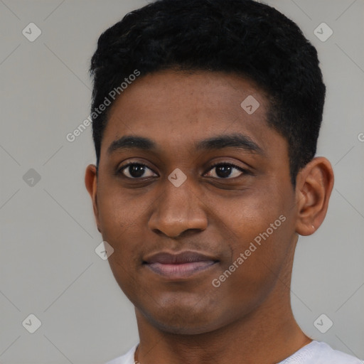 Joyful black young-adult male with short  black hair and brown eyes