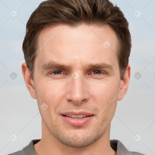 Joyful white young-adult male with short  brown hair and grey eyes