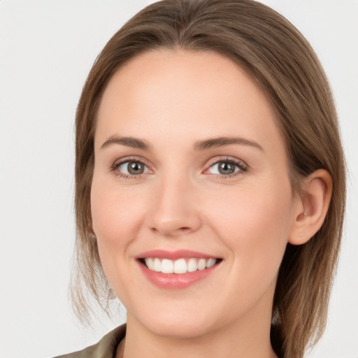 Joyful white young-adult female with long  brown hair and grey eyes