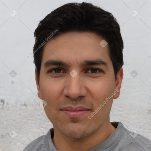 Joyful white young-adult male with short  black hair and brown eyes