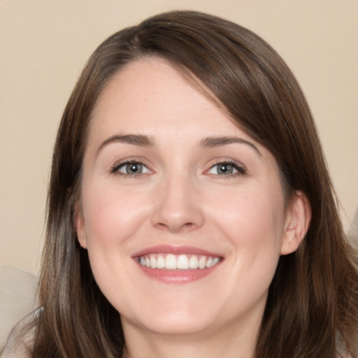 Joyful white young-adult female with long  brown hair and brown eyes