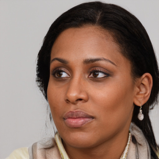 Neutral latino young-adult female with medium  brown hair and brown eyes