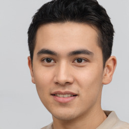 Joyful asian young-adult male with short  brown hair and brown eyes