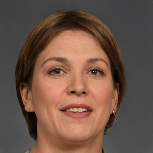 Joyful white adult female with medium  brown hair and grey eyes