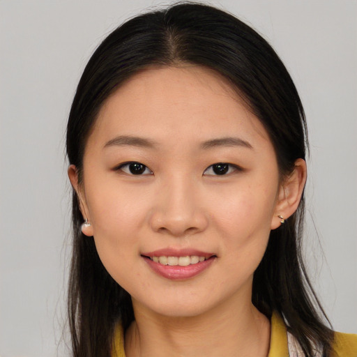 Joyful asian young-adult female with long  brown hair and brown eyes