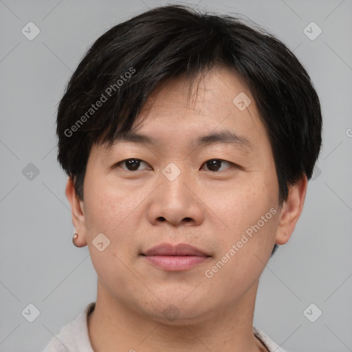 Joyful asian young-adult male with short  brown hair and brown eyes