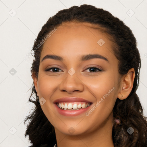 Joyful latino young-adult female with long  black hair and brown eyes