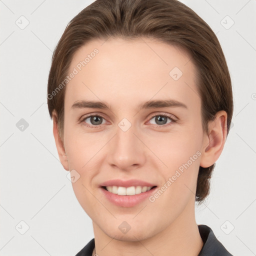 Joyful white young-adult female with short  brown hair and grey eyes