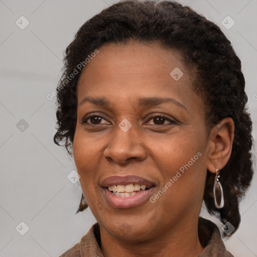 Joyful black adult female with medium  brown hair and brown eyes