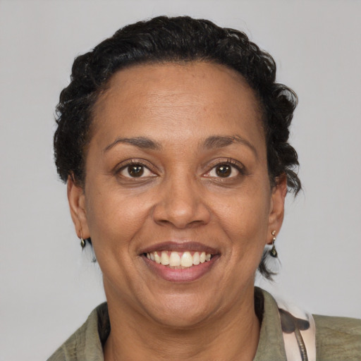 Joyful black adult female with short  brown hair and brown eyes