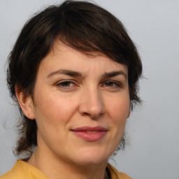 Joyful white adult female with medium  brown hair and brown eyes