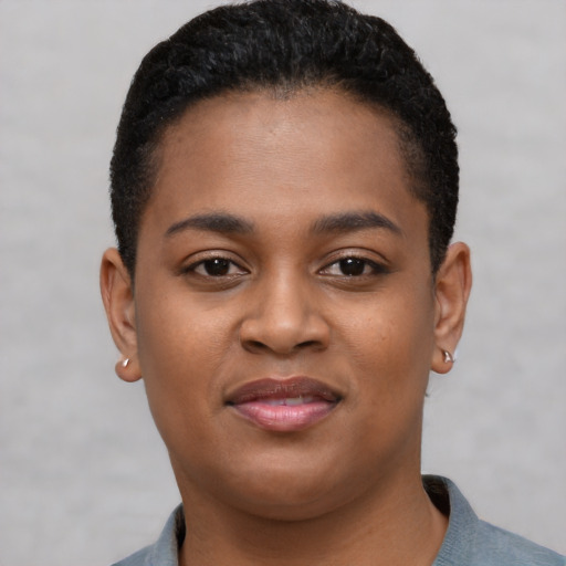 Joyful black young-adult female with short  brown hair and brown eyes