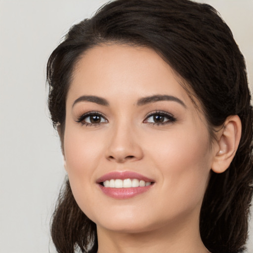 Joyful white young-adult female with long  brown hair and brown eyes