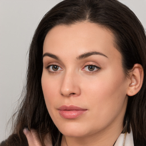 Neutral white young-adult female with long  brown hair and brown eyes