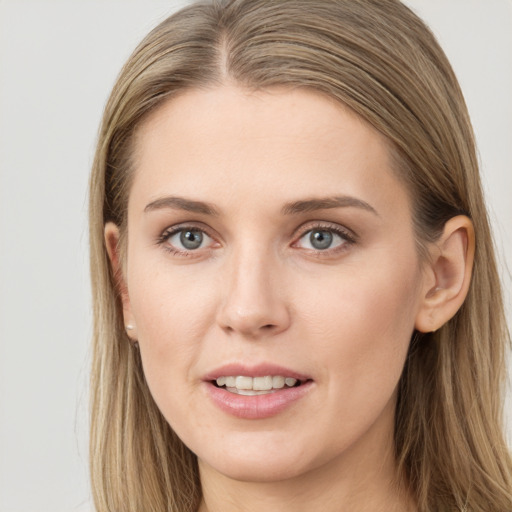 Joyful white young-adult female with long  brown hair and grey eyes