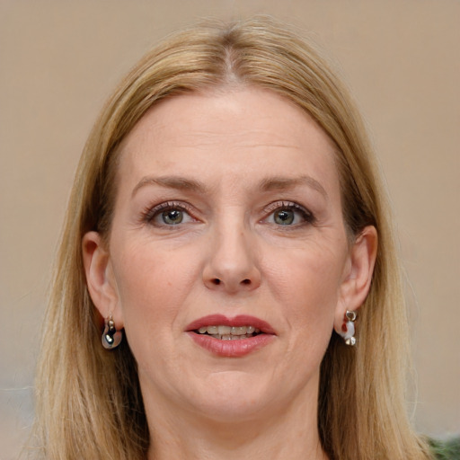 Joyful white adult female with long  brown hair and grey eyes