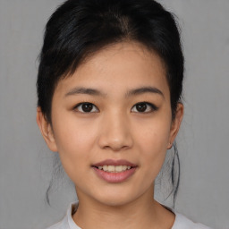 Joyful asian young-adult female with short  black hair and brown eyes