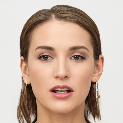 Joyful white young-adult female with long  brown hair and grey eyes