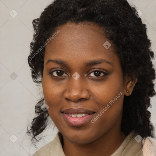 Joyful black young-adult female with long  black hair and brown eyes