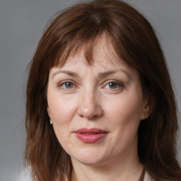 Joyful white adult female with medium  brown hair and grey eyes