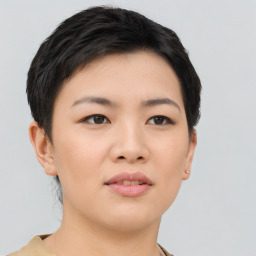 Joyful asian young-adult female with short  black hair and brown eyes