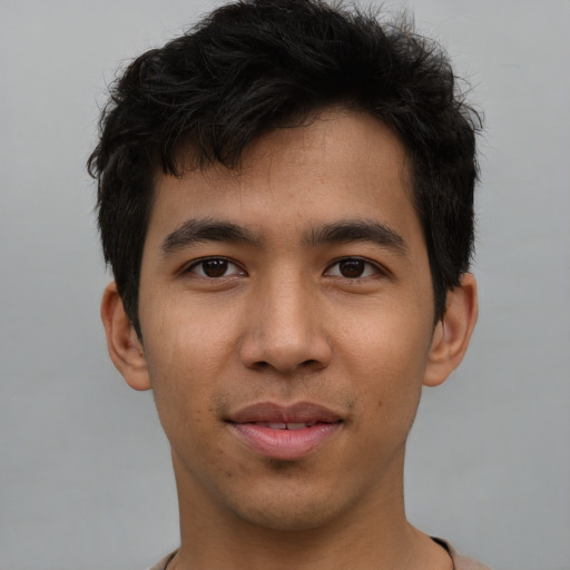 Joyful asian young-adult male with short  brown hair and brown eyes