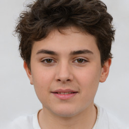 Joyful white child male with short  brown hair and brown eyes