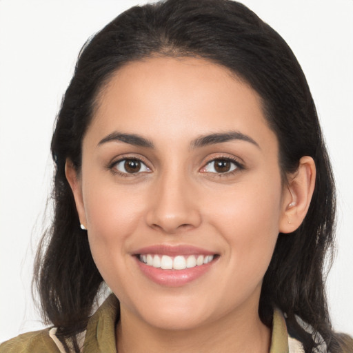 Joyful white young-adult female with long  brown hair and brown eyes