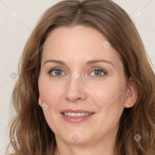 Joyful white young-adult female with long  brown hair and blue eyes