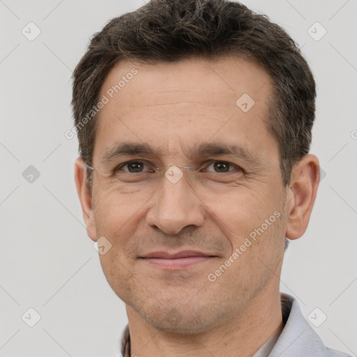 Joyful white adult male with short  brown hair and brown eyes