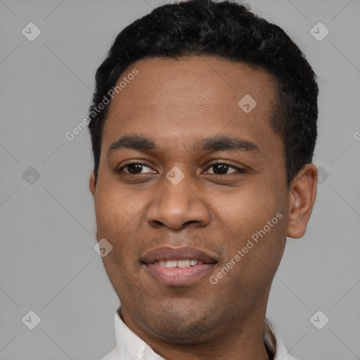 Joyful black young-adult male with short  black hair and brown eyes