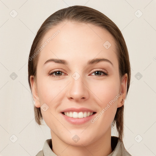 Joyful white young-adult female with medium  brown hair and grey eyes