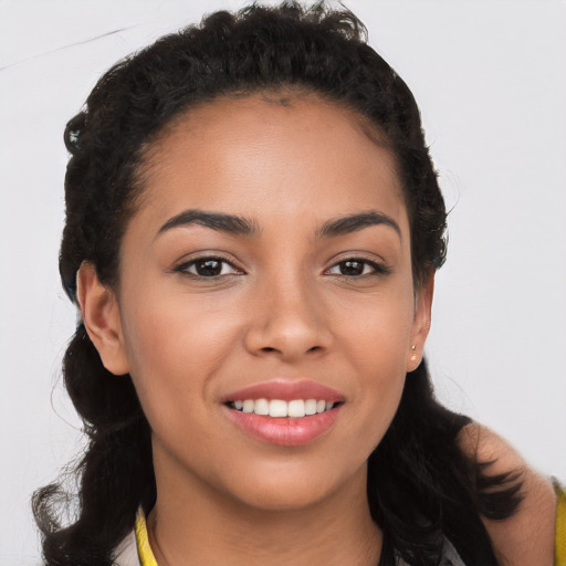 Joyful latino young-adult female with long  black hair and brown eyes