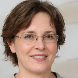 Joyful white adult female with medium  brown hair and brown eyes