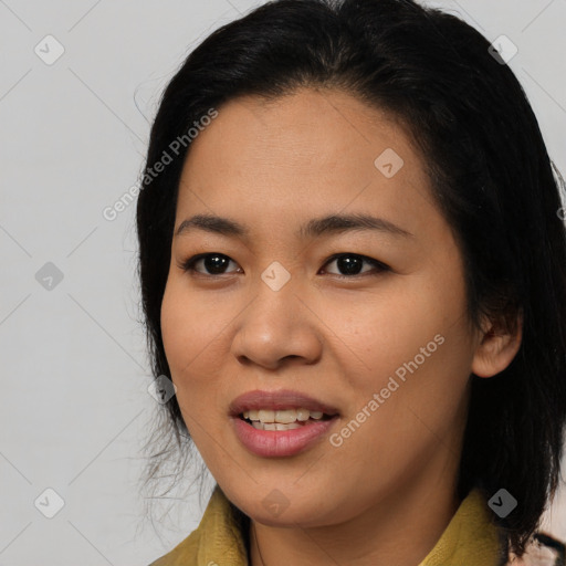 Joyful latino young-adult female with medium  black hair and brown eyes