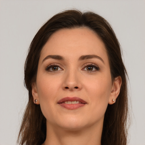 Joyful white young-adult female with long  brown hair and brown eyes