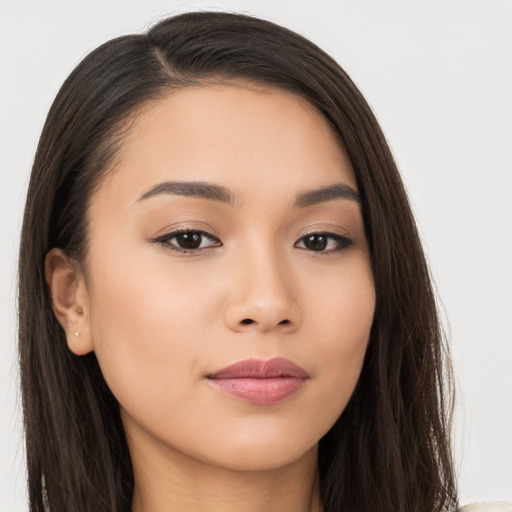 Joyful asian young-adult female with long  brown hair and brown eyes