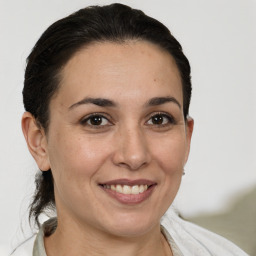 Joyful white adult female with short  brown hair and brown eyes