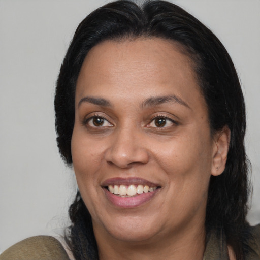 Joyful black adult female with medium  brown hair and brown eyes