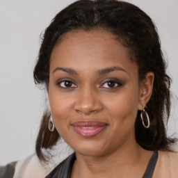 Joyful black young-adult female with medium  brown hair and brown eyes