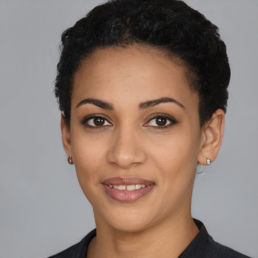 Joyful latino young-adult female with short  black hair and brown eyes