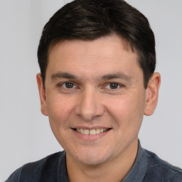 Joyful white young-adult male with short  brown hair and brown eyes