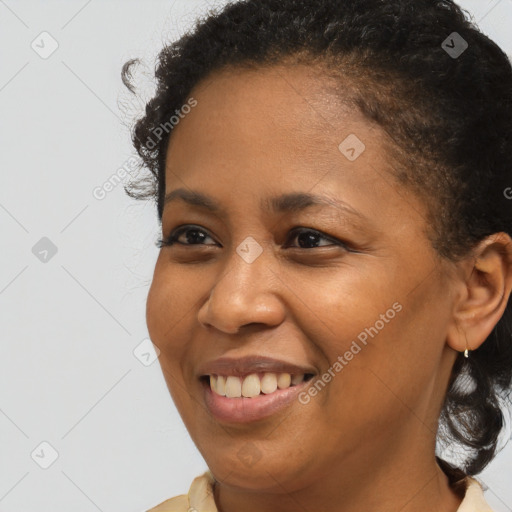 Joyful black young-adult female with short  brown hair and brown eyes