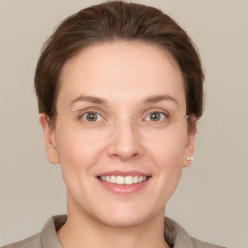 Joyful white young-adult female with short  brown hair and grey eyes