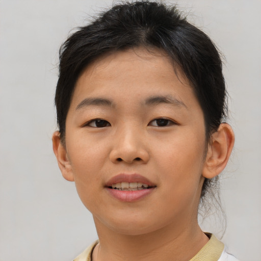 Joyful asian young-adult female with short  brown hair and brown eyes