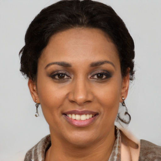 Joyful latino young-adult female with short  brown hair and brown eyes